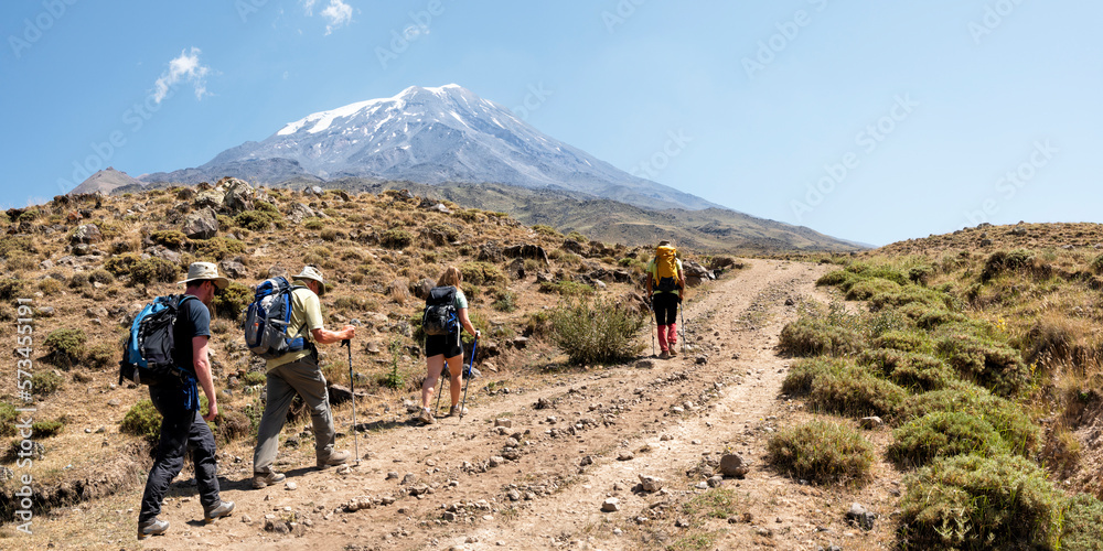 Friends hiking towards Mount Ararat on sunny day Friends hiking towards Mount Ararat on sunny day