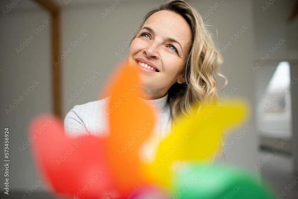 Happy mature woman with pinwheel toy day dreaming Happy mature woman with pinwheel toy day dreaming