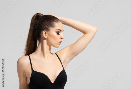 Close-up fashion portrait of beautiful, fresh, healthy and sensual girl over grey background
