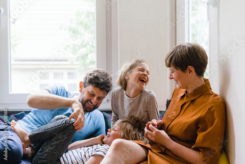 Happy family enjoying together sitting at home