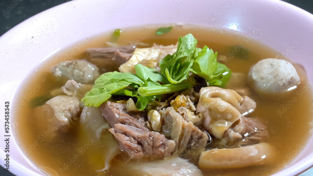 delicious beef stew with entrails and meatballs are decorated by green vegetable. Close up with studio light. delicious beef stew with entrails and meatballs are decorated by green vegetable. Close up with studio light.