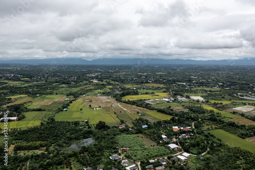 seen from a high perspective. Note the contrast between the sky s circling clouds and the green grass trees at Pa Sang District  Lamphun Province  Thailand.