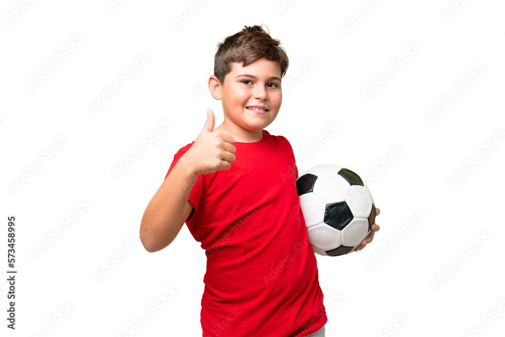 Little caucasian kid over isolated chroma key background with soccer ball and with thumb up