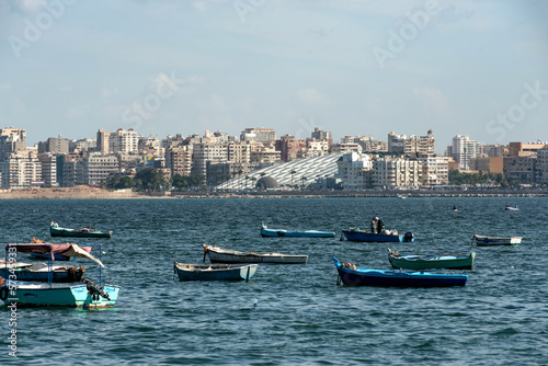 Local fishermen and fishing boats moored in the Mediterranean harbor of the Egyptian Delta port city of Alexandria, Egypt. .