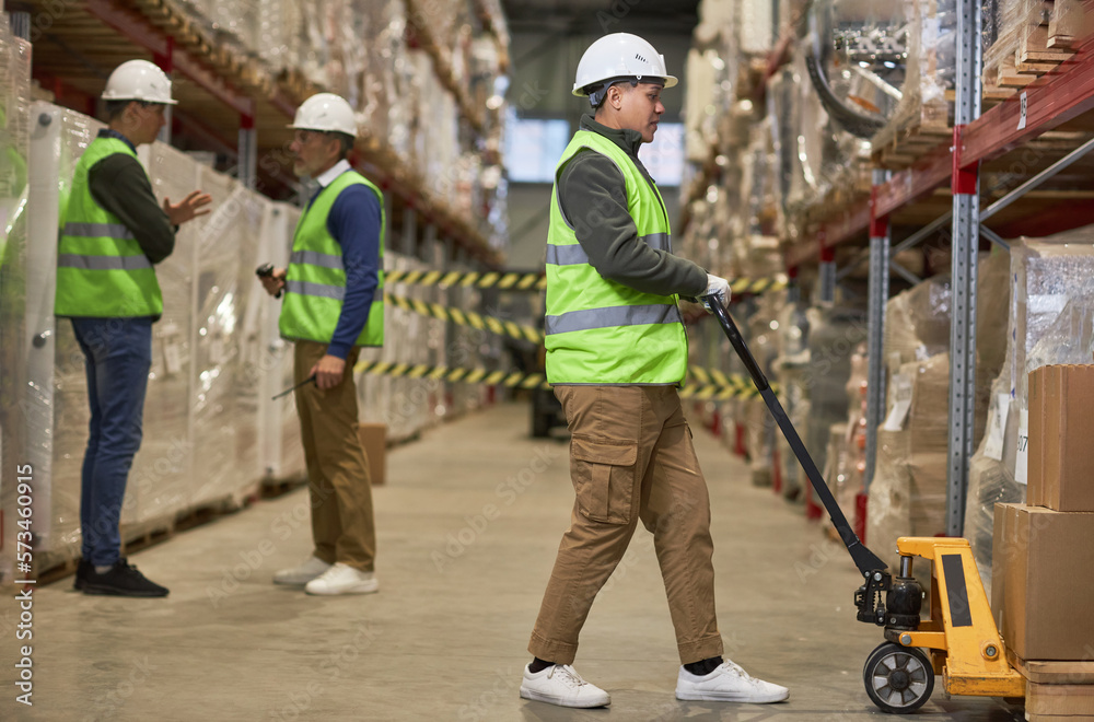 Full length shot of three workers doing operations in storage warehouse