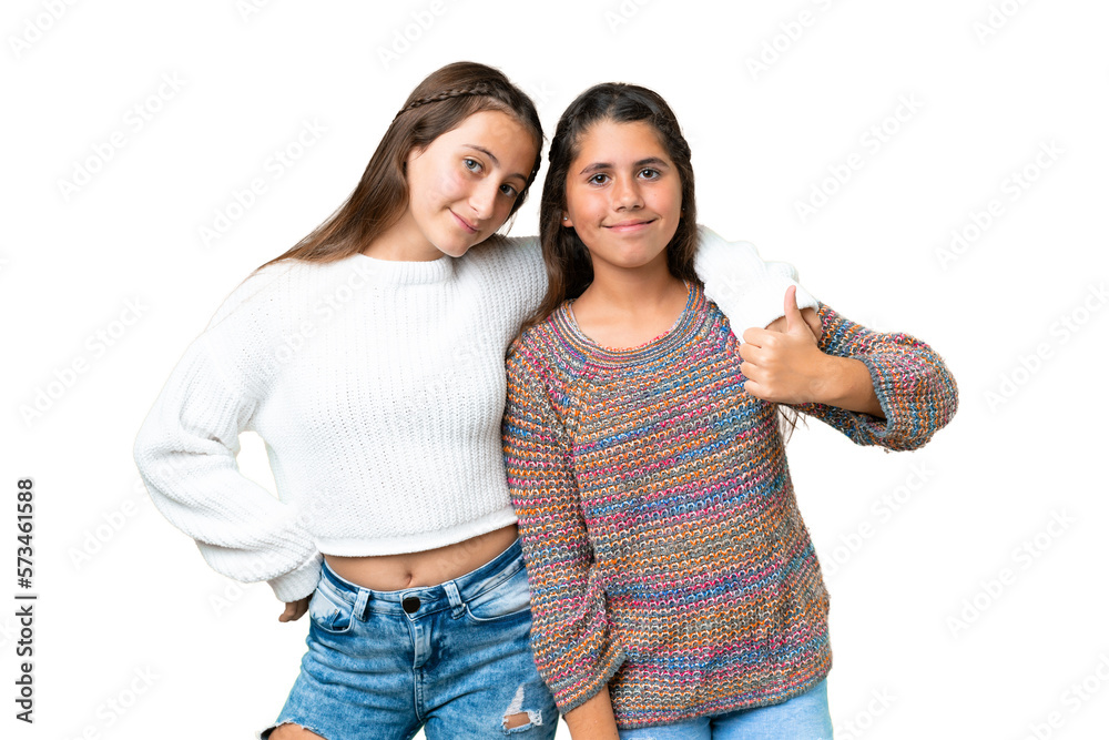 Friends girls over isolated chroma key background giving a thumbs up gesture Friends girls over isolated chroma key background giving a thumbs up gesture