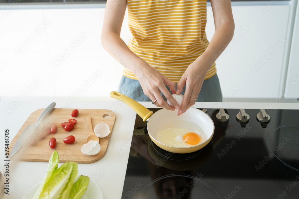 Woman making fried eggs at home Woman making fried eggs at home