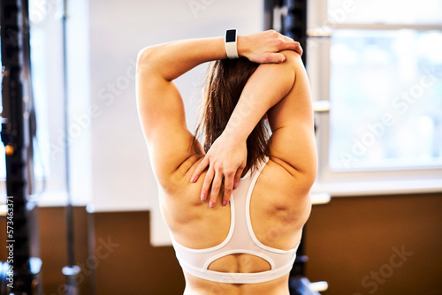 Woman stretching back and triceps muscles