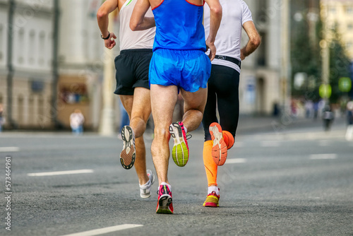 back three male athletes runners run marathon on avenue © sports photos
