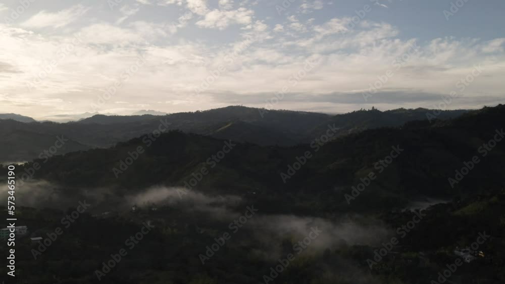 sunrise between clouds and mountains sunrise between clouds and mountains