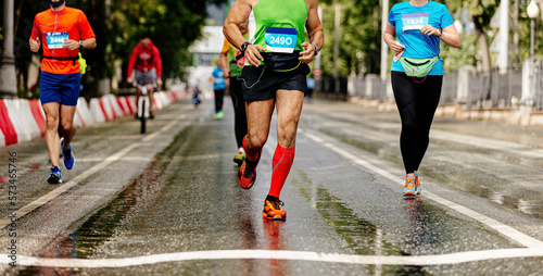 group runners athletes run on wet asphalt city marathon