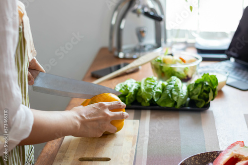 young woman preparing bell Pepper as a breakfast ingredient and ready for healthy cooking and on the table there are vegetables that are healthy organic ingredients. healthy food preparation ideas