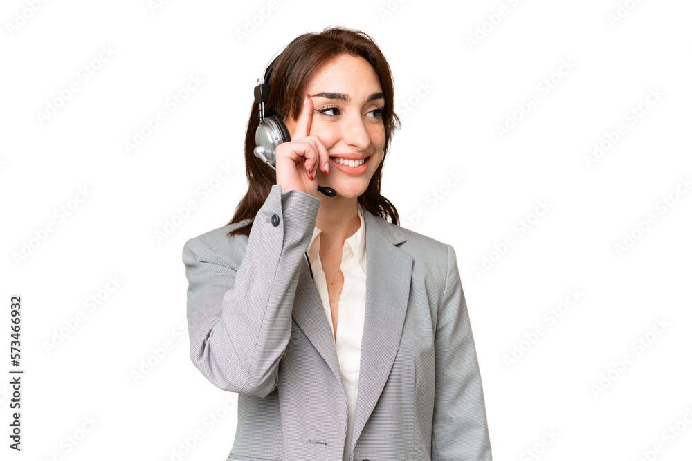 Telemarketer caucasian woman working with a headset over isolated chroma key background thinking an idea while looking up Telemarketer caucasian woman working with a headset over isolated chroma key background thinking an idea while looking up