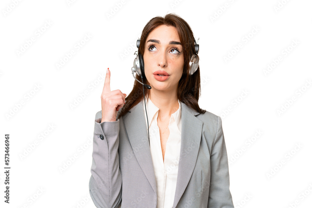 Telemarketer caucasian woman working with a headset over isolated chroma key background pointing up and surprised Telemarketer caucasian woman working with a headset over isolated chroma key background pointing up and surprised