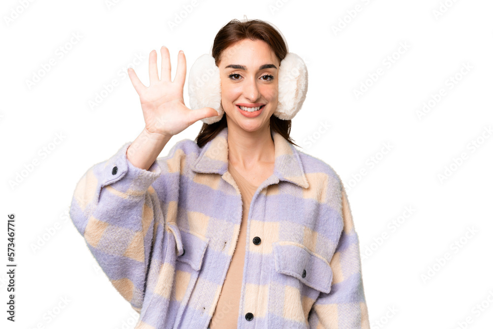 Young caucasian woman wearing winter muffs over isolated chroma key background counting five with fingers Young caucasian woman wearing winter muffs over isolated chroma key background counting five with fingers