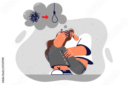Depressed woman sits on ground contemplating suicide due to unresolved issues in personal life