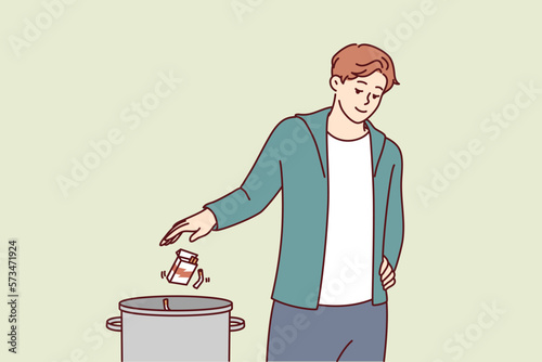 Man throws pack of cigarettes into trash can after quitting bad habit of smoking that causes cancer. Guy quits smoking and wants to start healthy lifestyle without dependence on nicotine or tobacco 