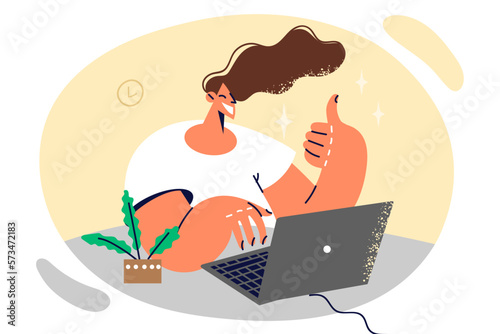 Woman freelancer typing text on laptop keyboard showing thumb up and smiling working remotely