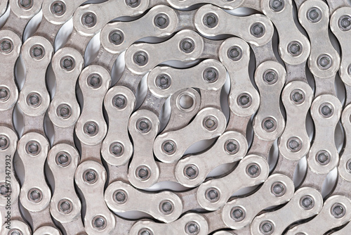 Extreme Closeup Image of New Clean Oiled Twisted Circled Bicycle Chain Isolated Over White Background. photo
