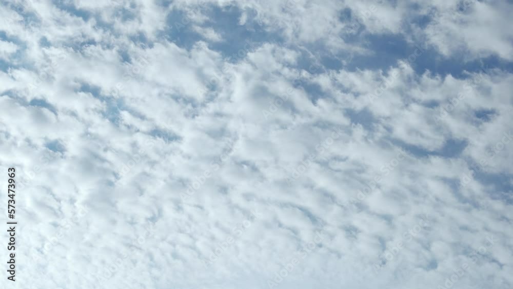 Sunny Blue Sky Fully Covered With White Puffy Cumulus Clouds on a Sunny Day Timelapse. White Fluffy Clouds in the Blue Sky in Sunlight, Cloudscape Time Lapse, Blue Firmament. Background 4K, Heaven. Sunny Blue Sky Fully Covered With White Puffy Cumulus Clouds on a Sunny Day Timelapse. White Fluffy Clouds in the Blue Sky in Sunlight, Cloudscape Time Lapse, Blue Firmament. Background 4K, Heaven.