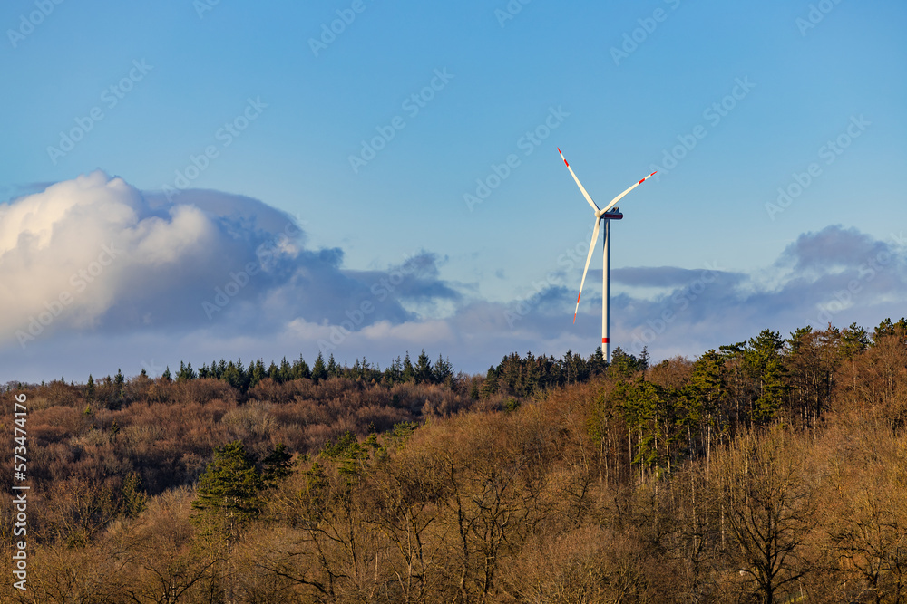Landscape of a rural region with trees and forest in front of a wind turbine, Baden-Wuerttemberg Landscape of a rural region with trees and forest in front of a wind turbine, Baden-Wuerttemberg