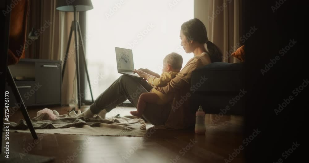 Working from Home: Portrait of Young Asian Mother, Holding her Cute Baby and Working on Laptop Computer During Day. Successful Female Architecte Balancing Life and Work while Doing her Job Remotely