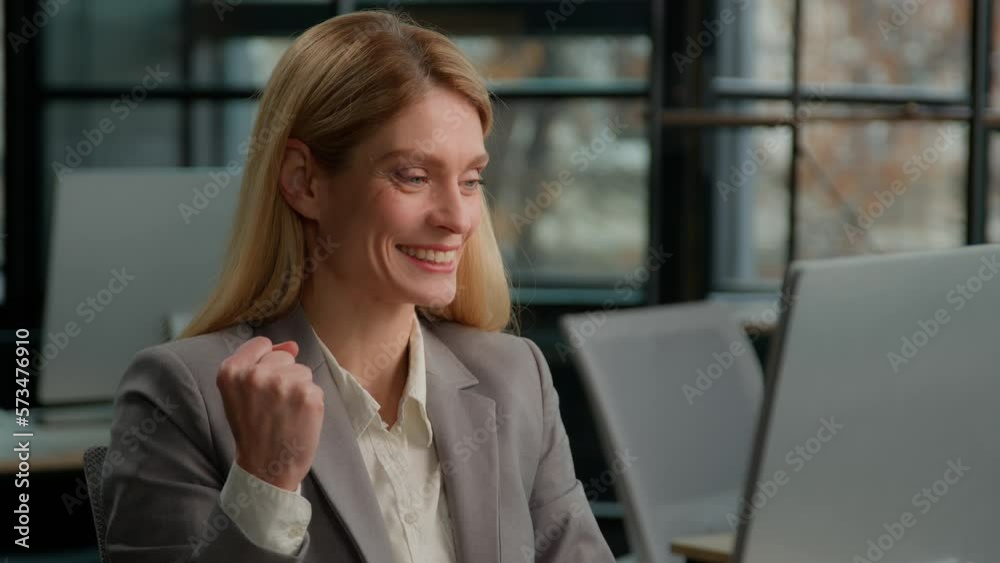 Caucasian middle-aged 40s woman sit in office use laptop check email in computer read good news offer sale price career promotion salary growth. Adult businesswoman winner celebrate online win victory Caucasian middle-aged 40s woman sit in office use laptop check email in computer read good news offer sale price career promotion salary growth. Adult businesswoman winner celebrate online win victory