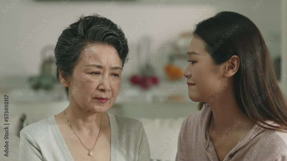 loving and caring asian adult daughter consoling sad senior mother at home loving and caring asian adult daughter consoling sad senior mother at home