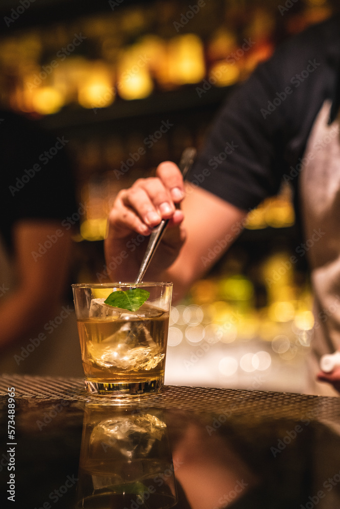 Bartender preparing cocktail into bar