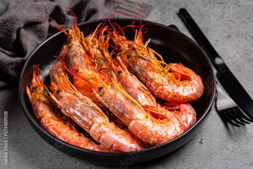 Giant argentinian red prawns, grilled. Plate with seafood. Dark grey background.