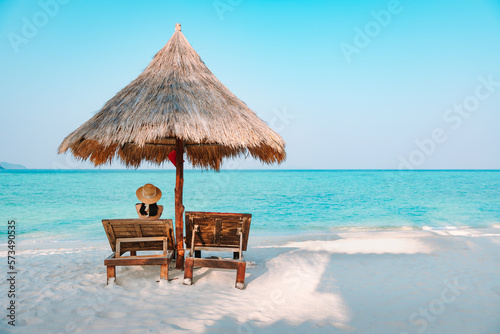 Happy traveler asian woman travel and relax on chair beach in summer Thailand photo