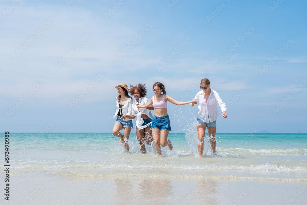 Happy friends at beach party runs together on the beach having fun in a sunny day, Beach summer holiday sea people concept Happy friends at beach party runs together on the beach having fun in a sunny day, Beach summer holiday sea people concept