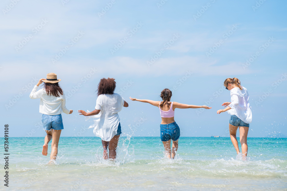 Happy friends at beach party runs together on the beach having fun in a sunny day, Beach summer holiday sea people concept Happy friends at beach party runs together on the beach having fun in a sunny day, Beach summer holiday sea people concept