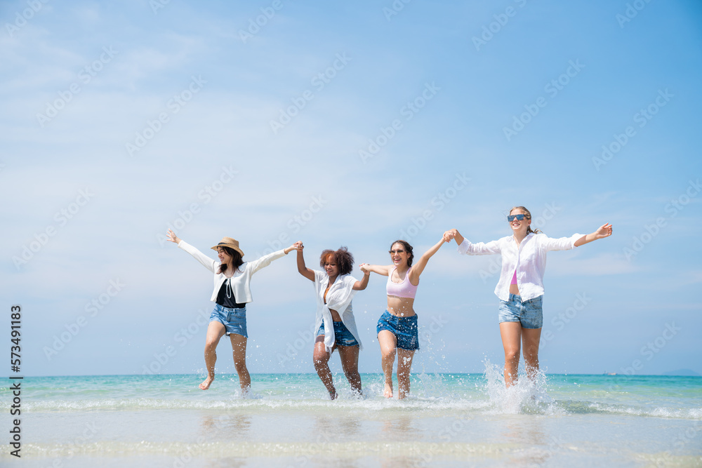 Happy friends at beach party runs together on the beach having fun in a sunny day, Beach summer holiday sea people concept