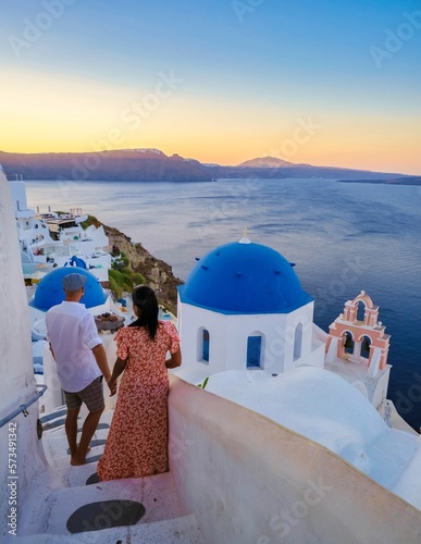 Couple on vacation in Santorini Greece, men, and women on the streets of the Greek village of Oia Santorini