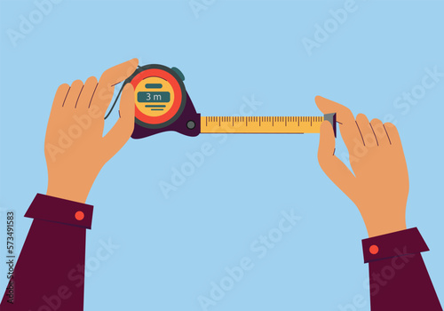 Measuring tape in the hands of a man. Tools for bulding and work. Stationery and office supply. Construction, engineering, repair concept.