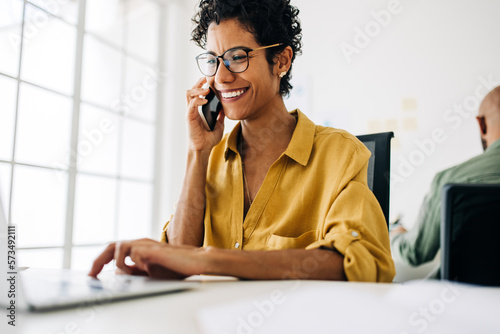 Female accountant talking on a phone call in an accounting firm