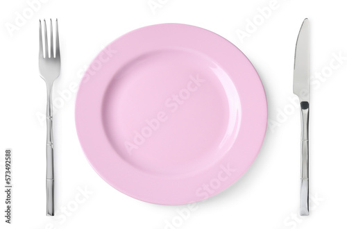 Empty pink plate with fork and knife on white background, top view