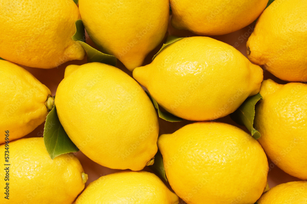Colorful bright background of fresh ripe sweet citrus fruits, yellow lemons from market, selective focus, shallow DOF