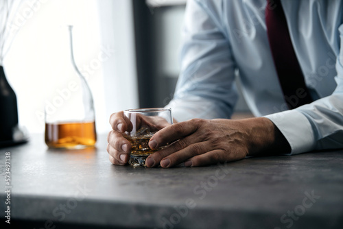 Close up businessman holding a glass of whiskey © opolja