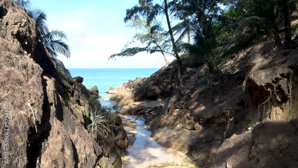 Aerial, forward, drone shot, over large stones and trees at banana beach. Aerial, forward, drone shot, over large stones and trees at banana beach.