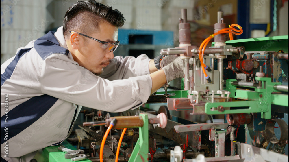 the technician repairing the machine in the factory the technician repairing the machine in the factory
