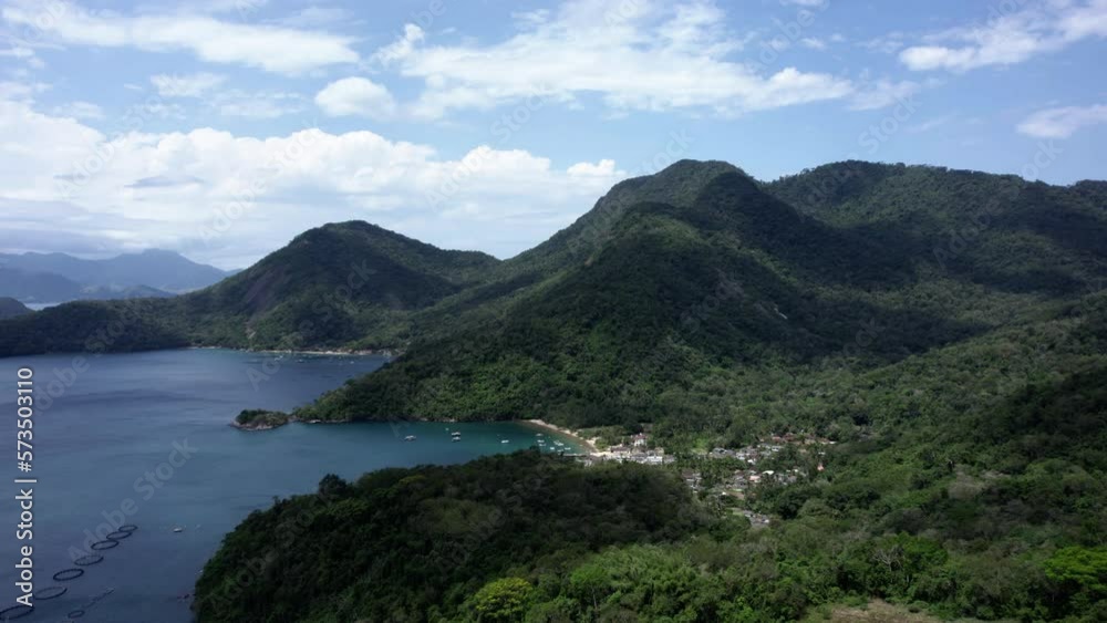 Aerial view over mountains and green vegetation, towards a town on Ilha Grande, Brazil Aerial view over mountains and green vegetation, towards a town on Ilha Grande, Brazil