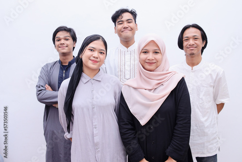 Muslim people in islamic wear smiling to the camera over white background