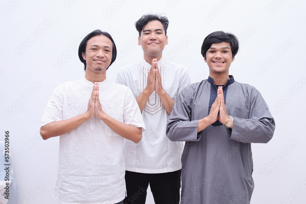 Muslim men showing greeting gesture and smiling to camera Muslim men showing greeting gesture and smiling to camera