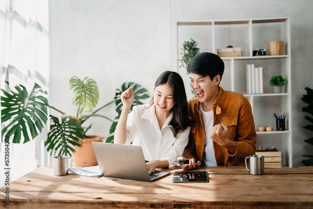 Young Asian business team creative businesspeople coworker, teamwork celebrating achievement and in planning design in creative in office. Young Asian business team creative businesspeople coworker, teamwork celebrating achievement and in planning design in creative in office.