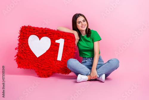 Full size portrait of cheerful gorgeous girl sit floor hold large like notification collage isolated on pink color background