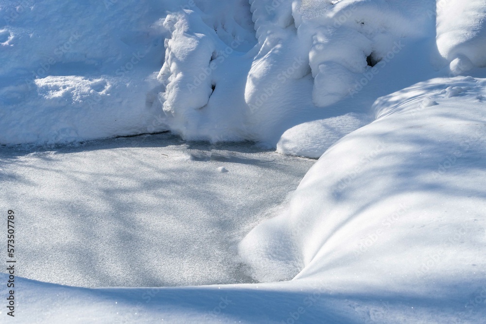 Magic garden pond under ice. Snowy winter. Winter fairy tale. Banks are covered with high snowdrifts. Atmosphere of relaxation, tranquility and happiness inwinter garden. Nature concept for design. Magic garden pond under ice. Snowy winter. Winter fairy tale. Banks are covered with high snowdrifts. Atmosphere of relaxation, tranquility and happiness inwinter garden. Nature concept for design.