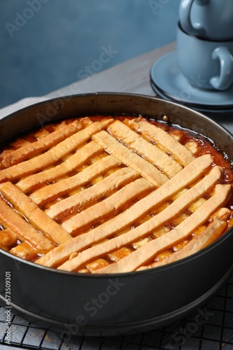 Delicious apricot pie in baking dish on table, closeup