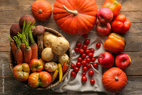 Fototapeta Naklejka Na Ścianę i Meble -  Different fresh ripe vegetables and fruits on wooden table, flat lay